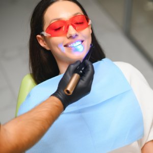 Teeth whitening in Midland with patient wearing protective glasses during professional whitening treatment.